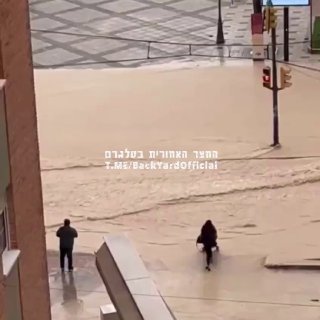 אם השנה של ספרד. ניסתה לחצות עם עגלת תינוק בזמן הצפה בעיר....